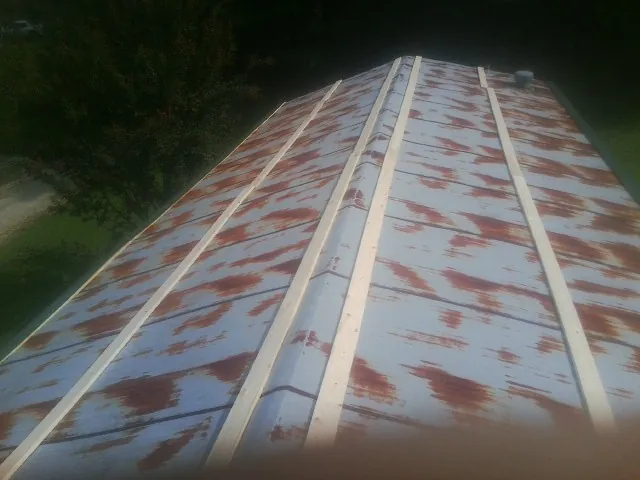 Rusted metal roof panels with new wood purlins before replacement — Storm Damage Roof Repair in Moodus by Roofing Brothers